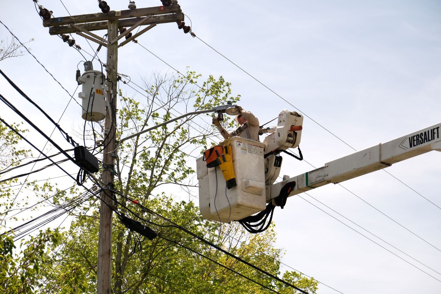Utility workers replacing old streetlights with new LED lights