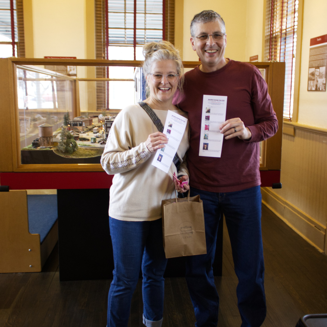 Couple holding cards for scavenger hunt 